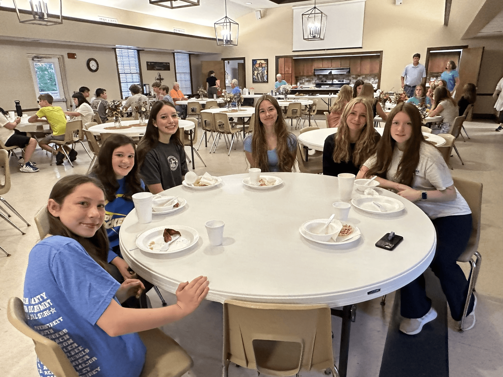 three men and laughing two women walking side by side