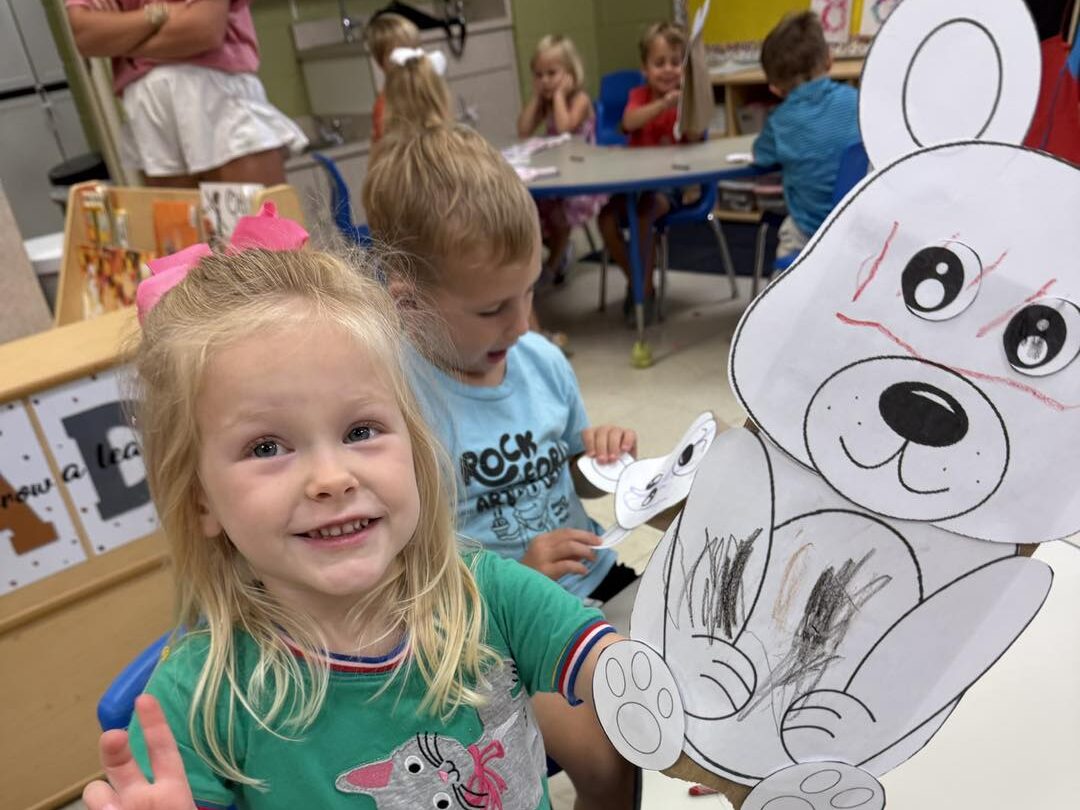 a child is drawing on a piece of paper