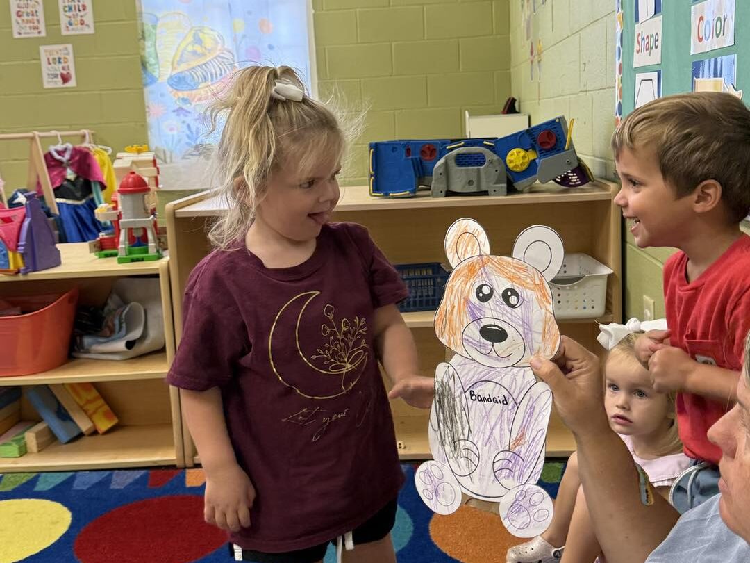 a child is drawing on a piece of paper