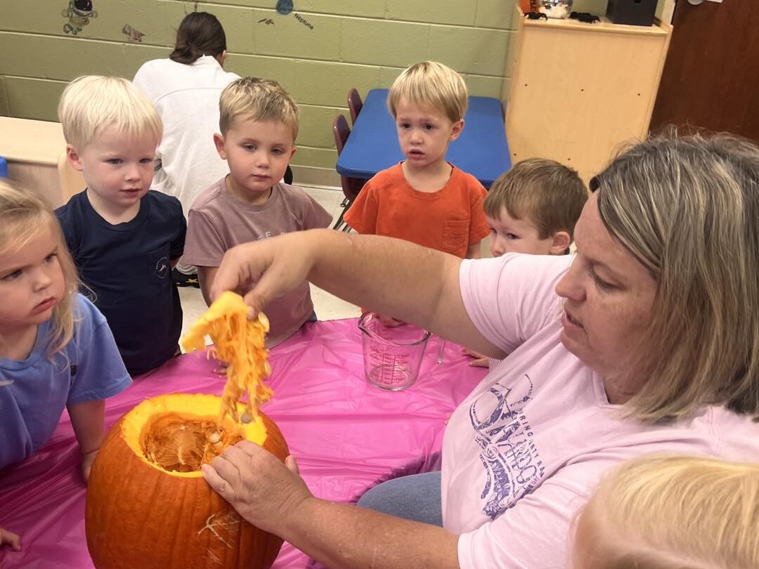 a child is drawing on a piece of paper